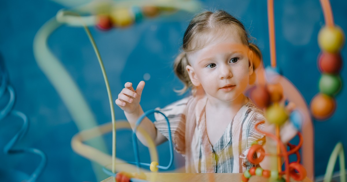 Young child plays with educational toys