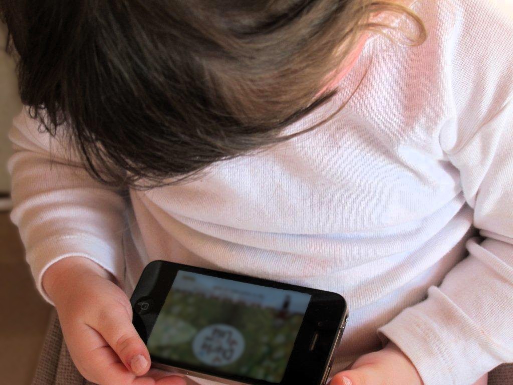 Young child watching phone 