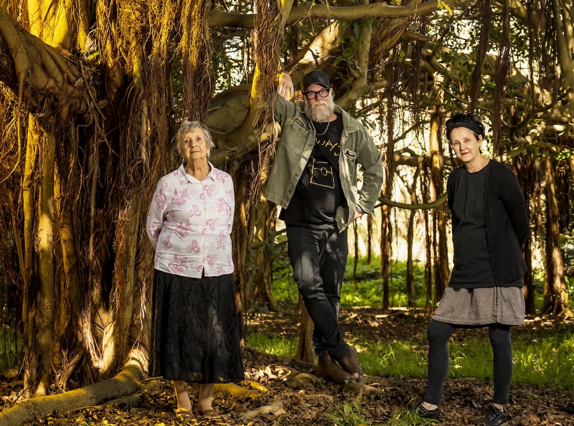 Storyland playwright Aunty Barbara Nicholson, director Leland Kean and playwright and author Catherine McKinnon stand under an enormous fig tree