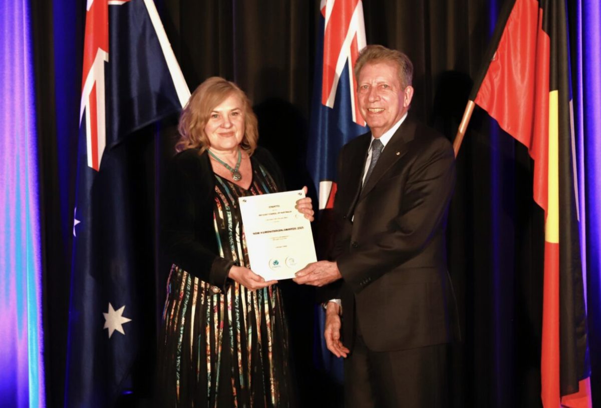 A man presenting a woman with an award