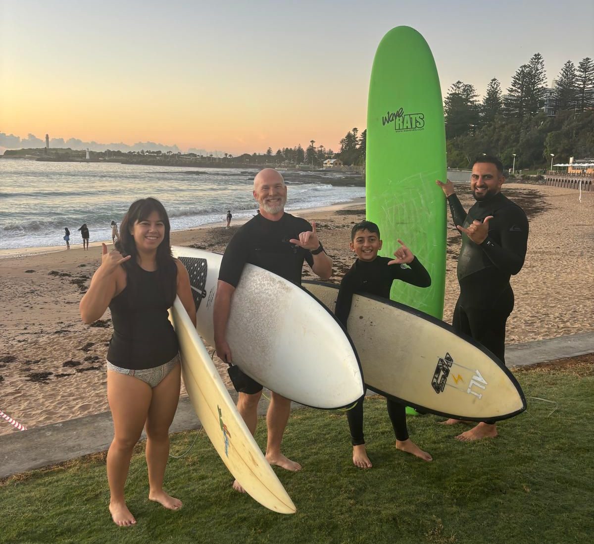 Four people with surfboards