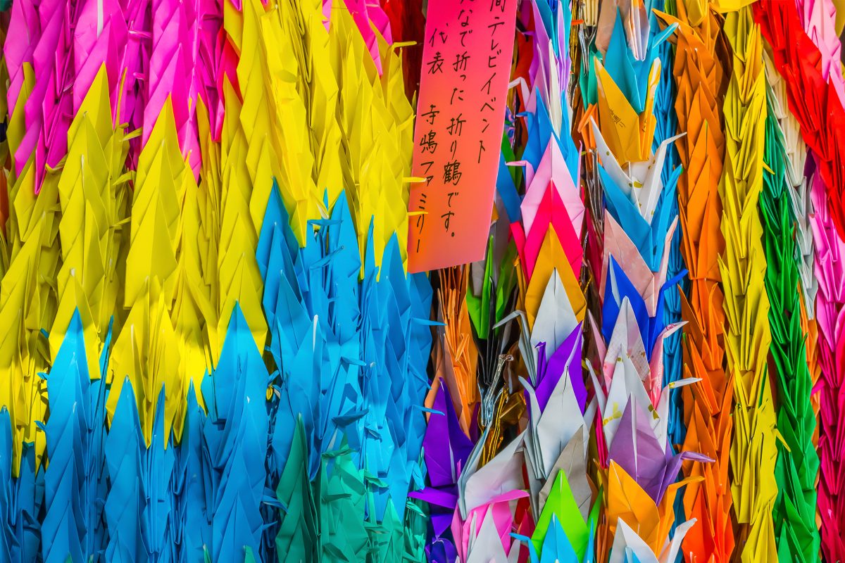 Stacks of colourful origami cranes