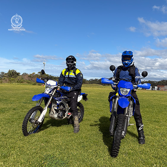Two police officers on dirt bikes.
