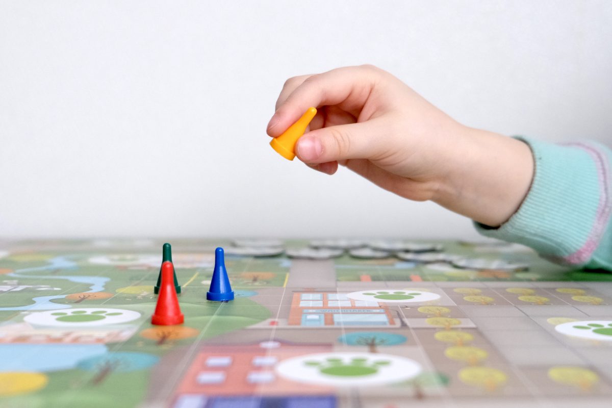 A child plays with board game pieces