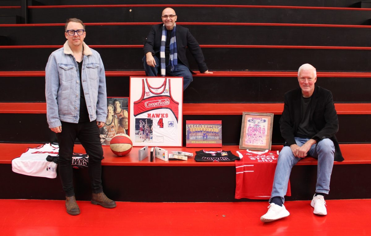 three men with basketball club paraphernalia