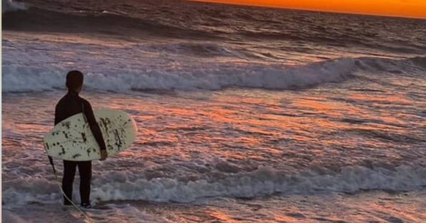 Father and son riding high on the simple kindness of a surfing stranger