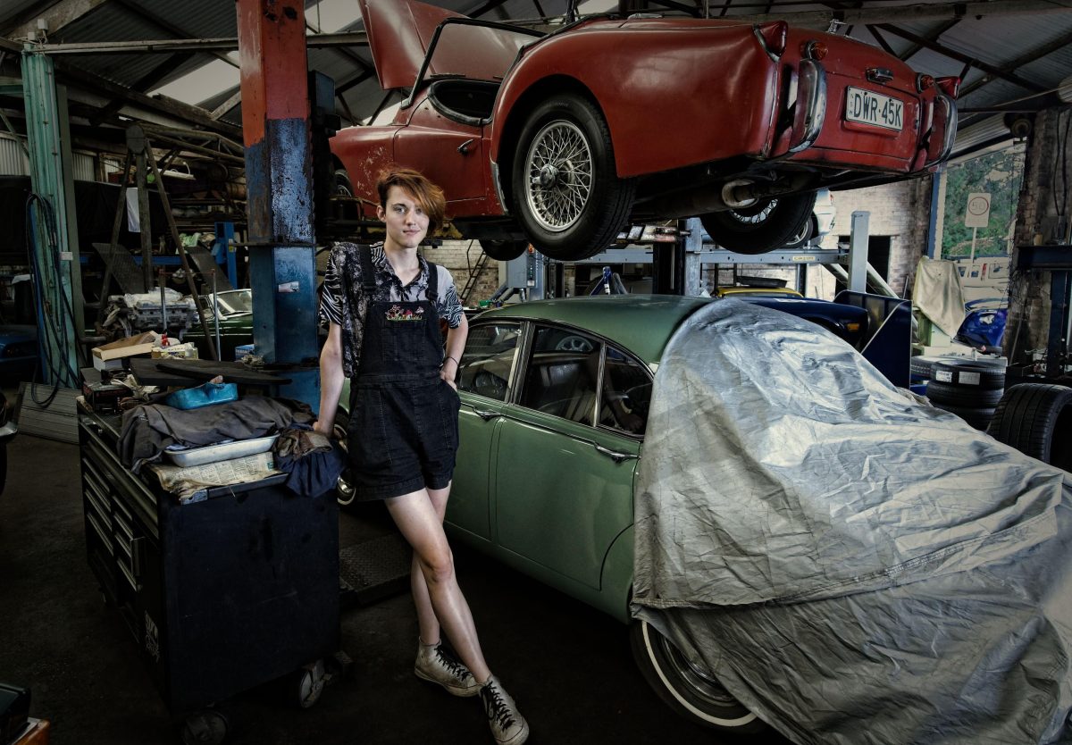 Attendant at Thirroul Service Station surrounded by cars