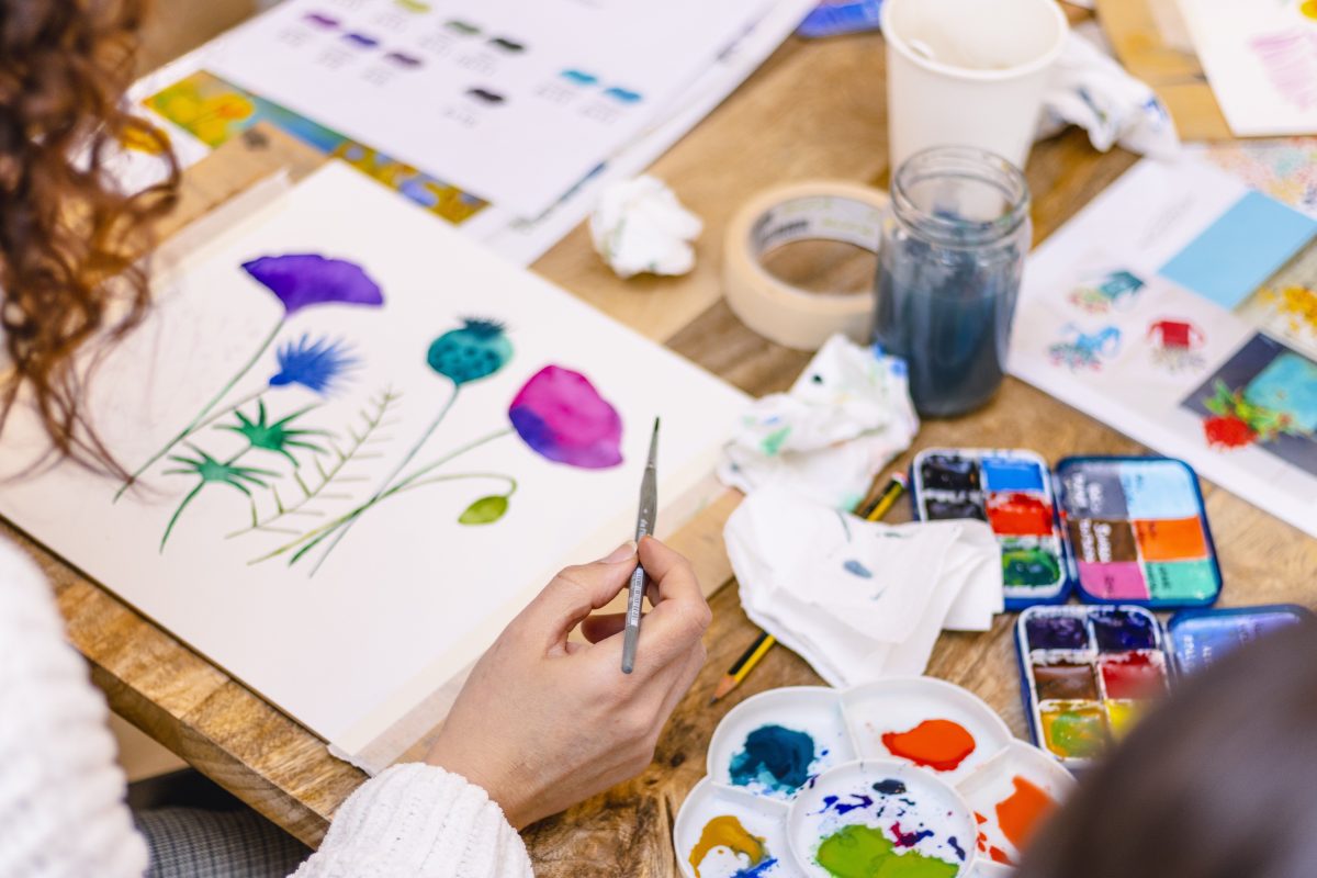 Artist paints watercolour florals