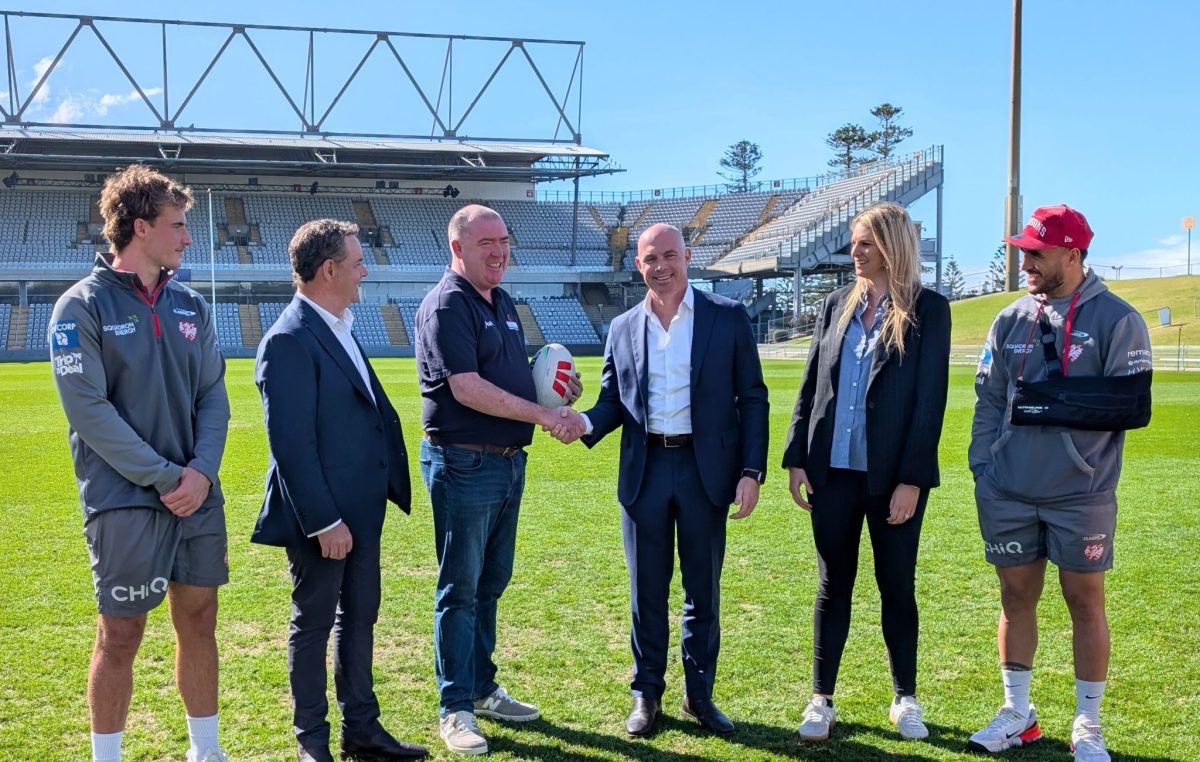 Mark Sleigh and Tim Watsford shaking hands with Dragon's players and staff.