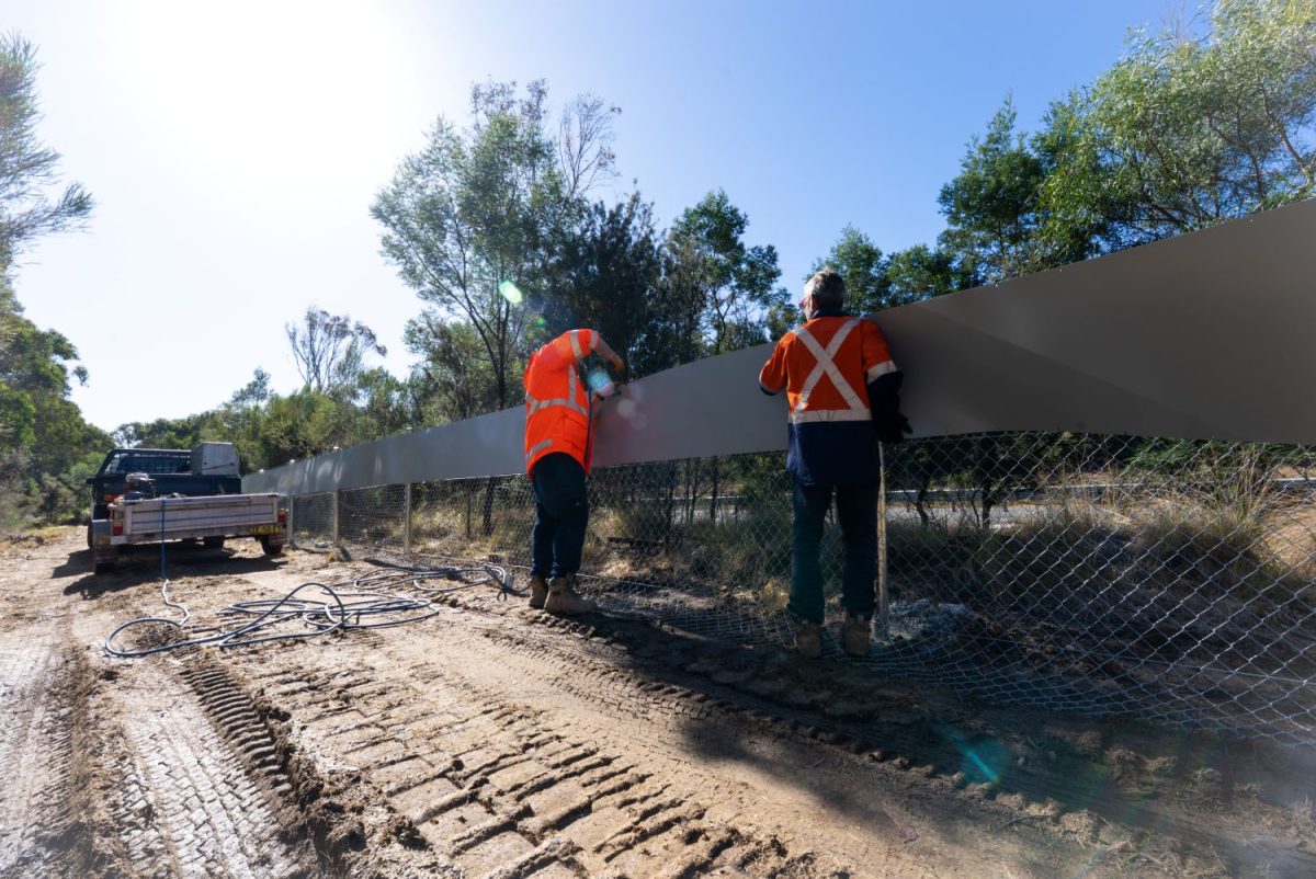 Workers installing fencing