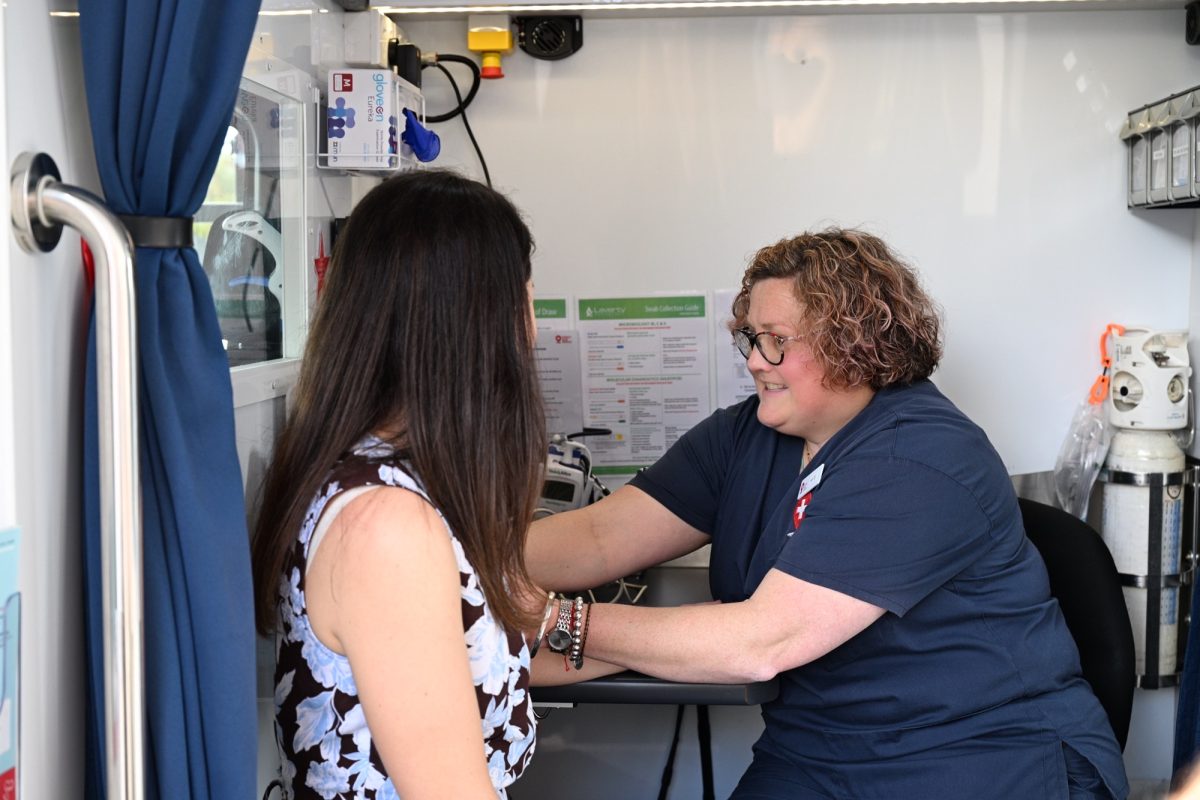A nurse checks blood pressure from a mobile clinic