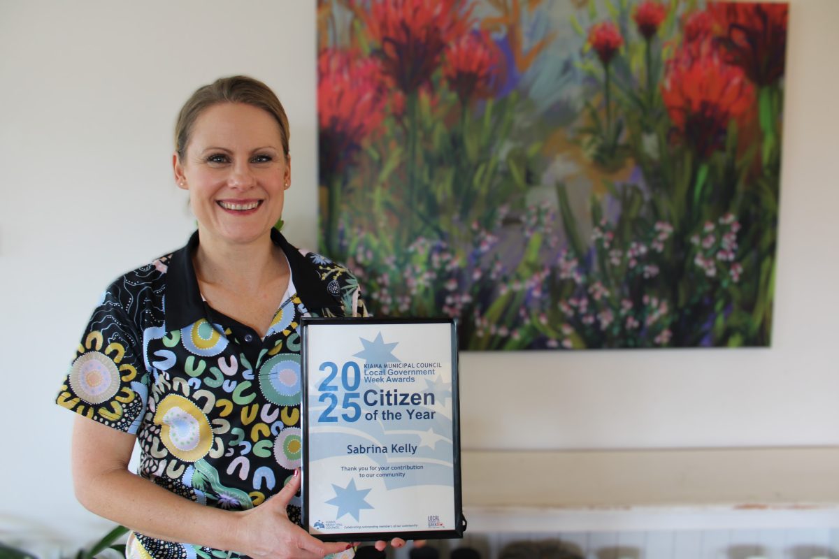 Woman holding an award certificate