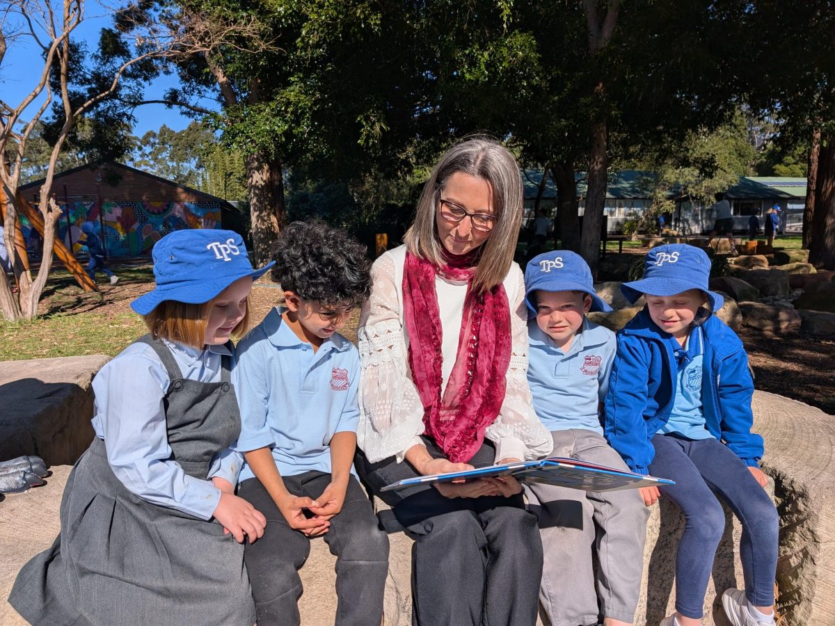 Delphine with students reading 