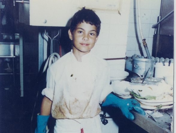 Andrew as a child washing dishes