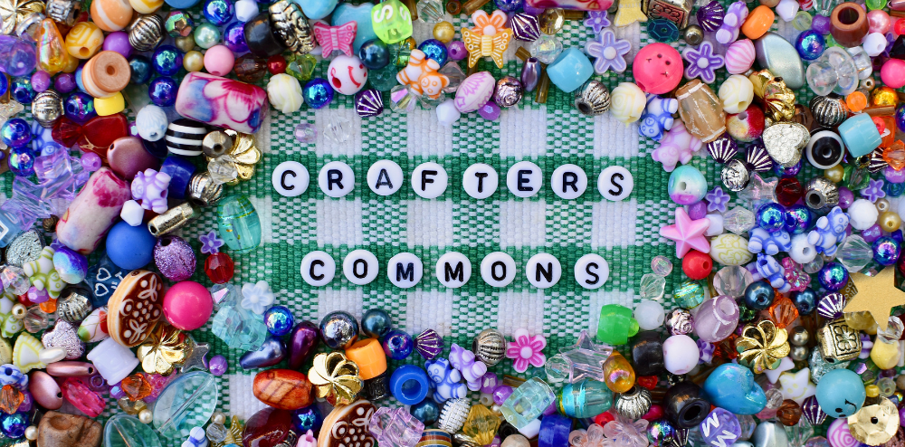 Beads on a table spelling Crafters Commons