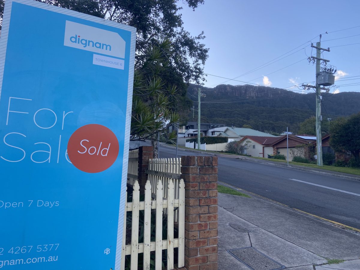 For sale sign and residential street in Coledale
