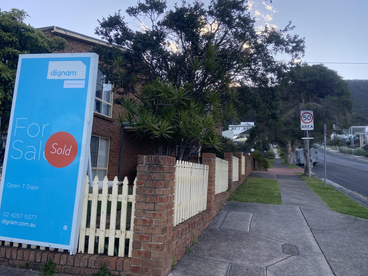 For sale sign and residential street in Coledale