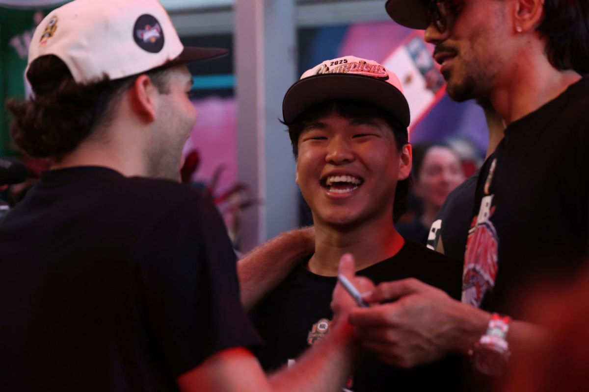 Kyu Hyun Shim with Hawks players Kobie McDowell-White and Will “Davo” Hickey.