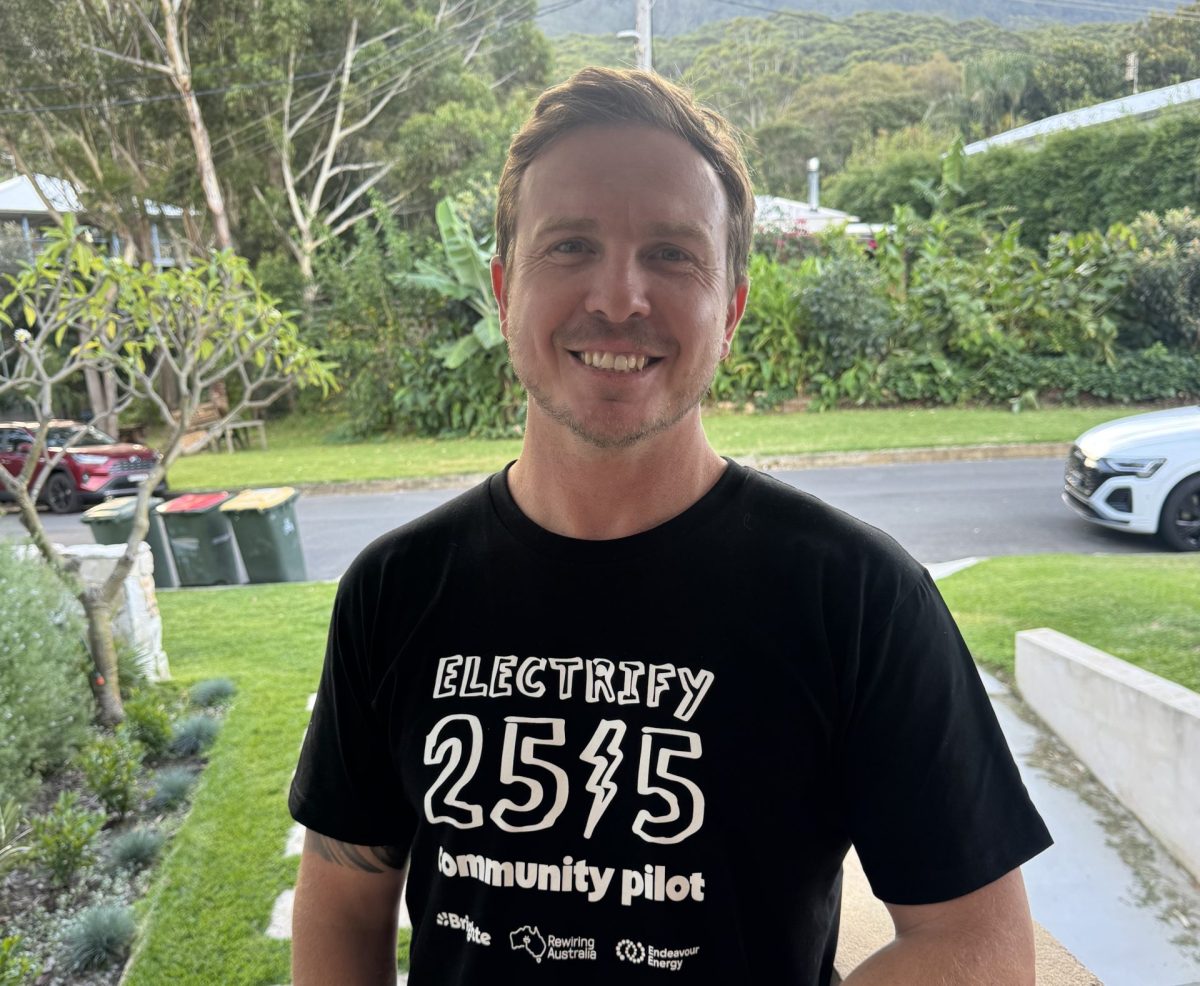 Man wears an Electrify 2515 tshirt