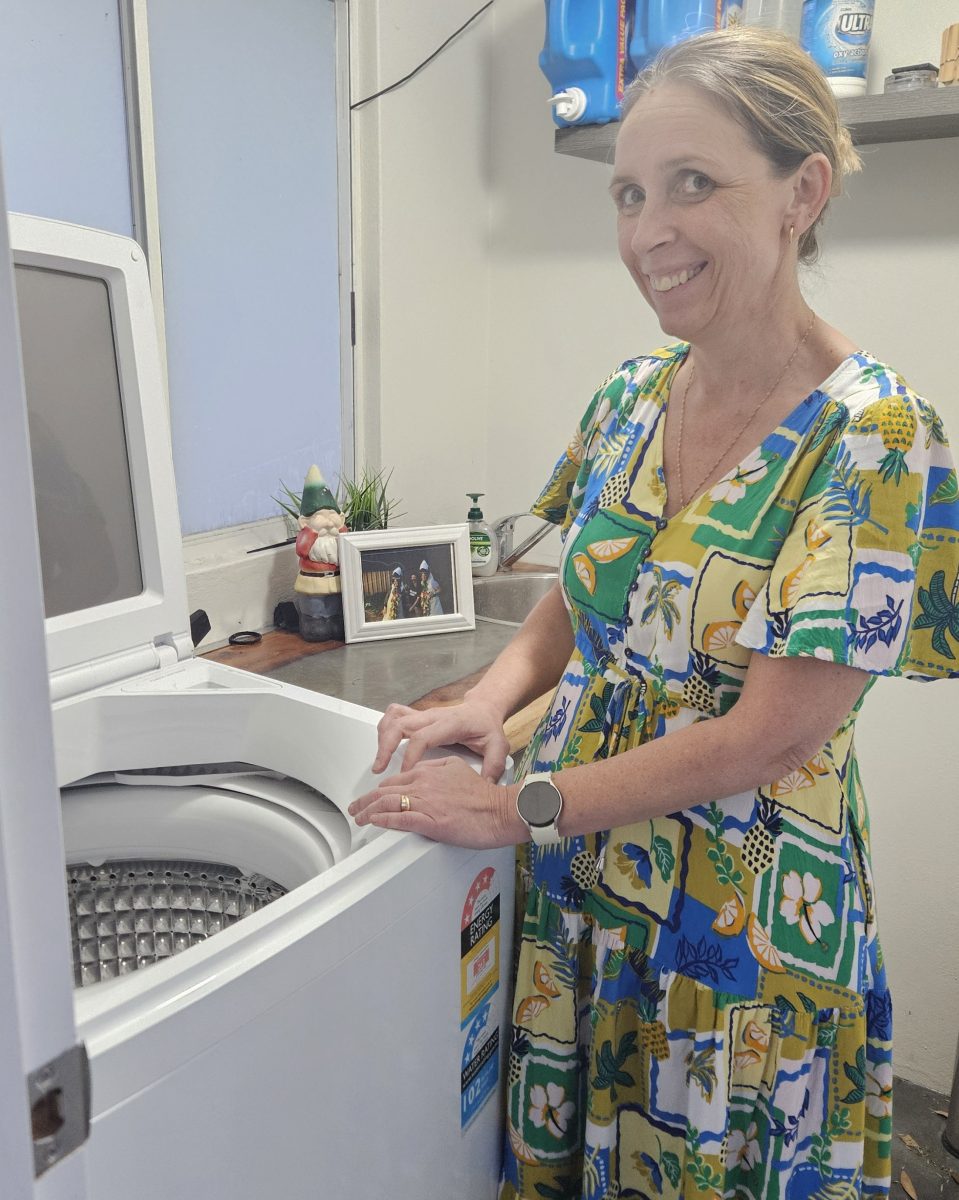 Woman at washing machine.
