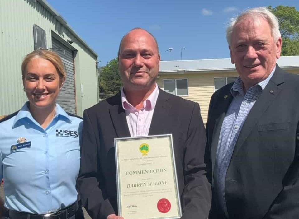 SES volunteer Nikki Ristoski with Darren Malone and Australasian Institute of Emergency Services President David Parsons, after Darren was awarded a commendation for his commitment to the community.