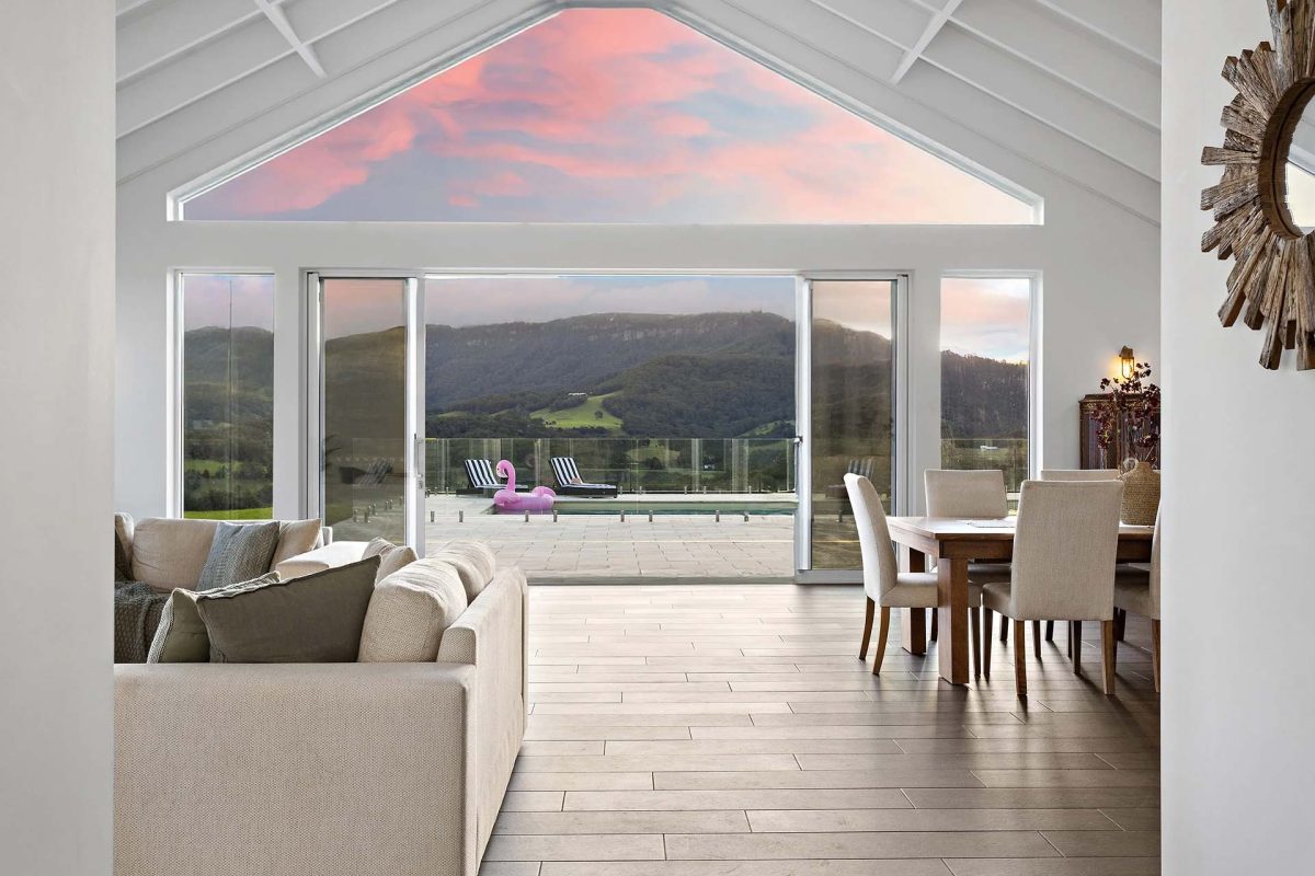 Open plan living room looking out to the escarpment and pool
