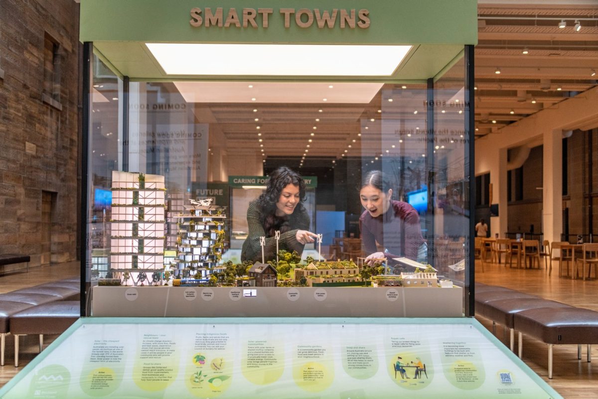 two people looking at a diorama through glass