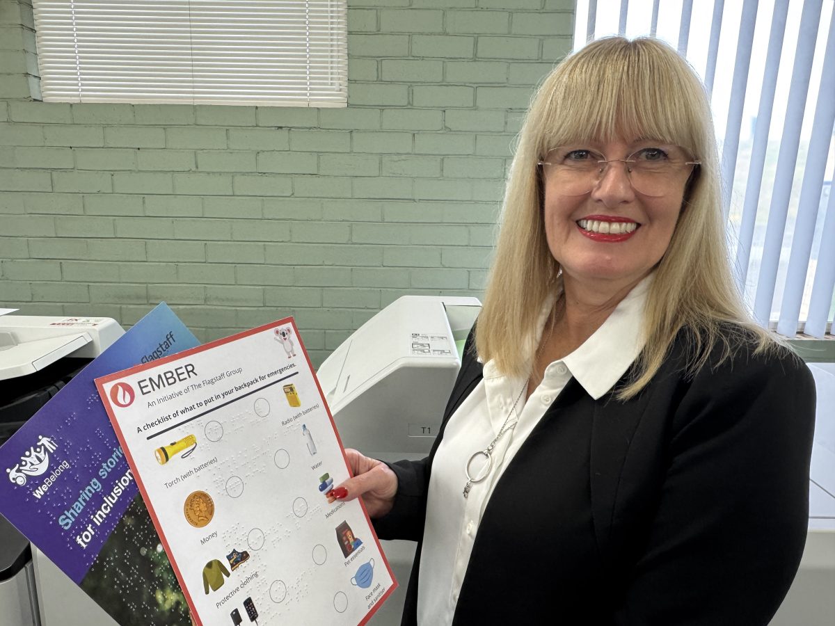 Flagstaff printer Lyn Whittington holds an example of brochures printed with braille.
