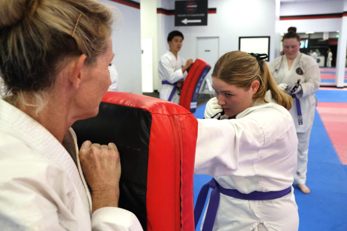 Woman with purple belt in karate class