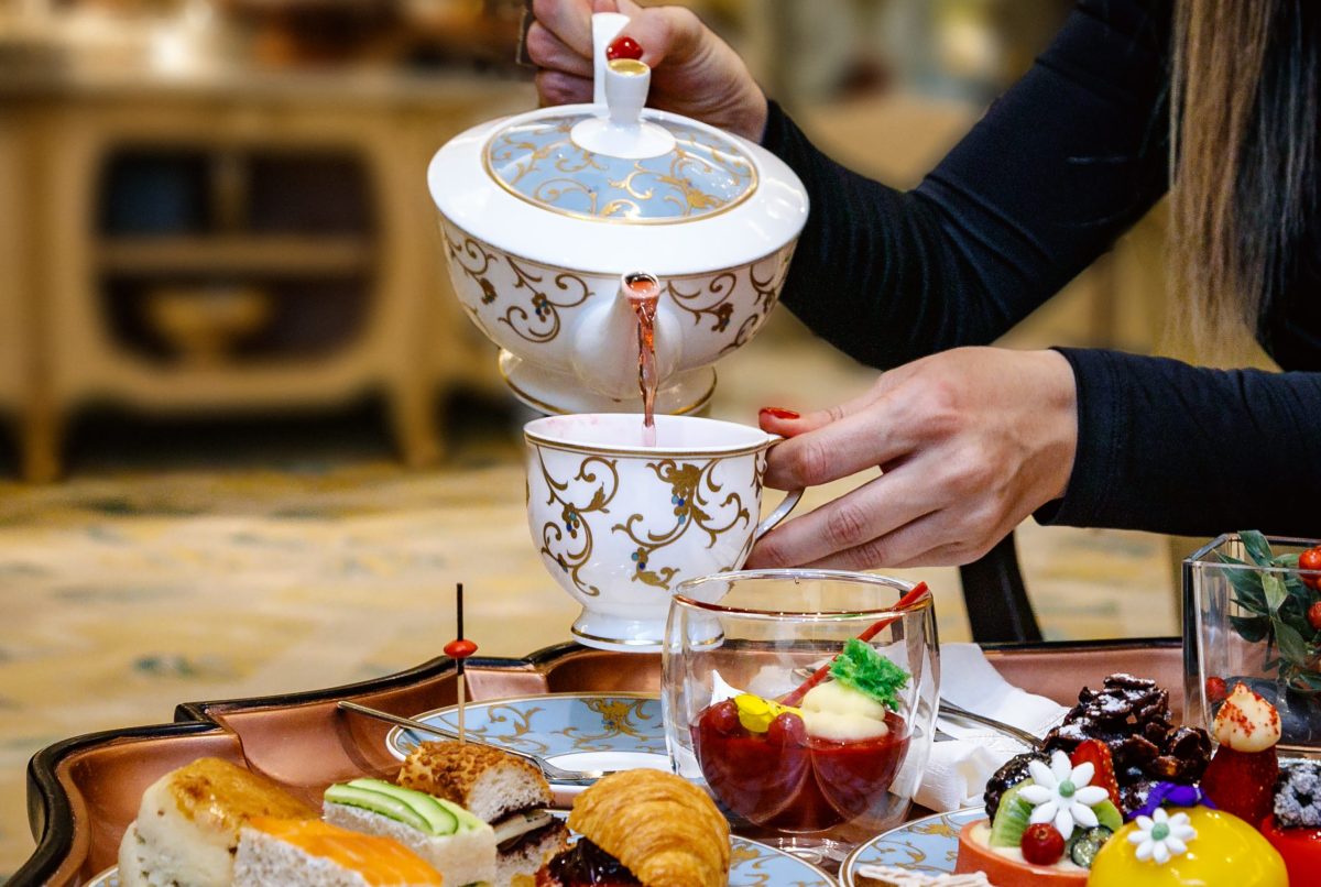 Hand pouring tea