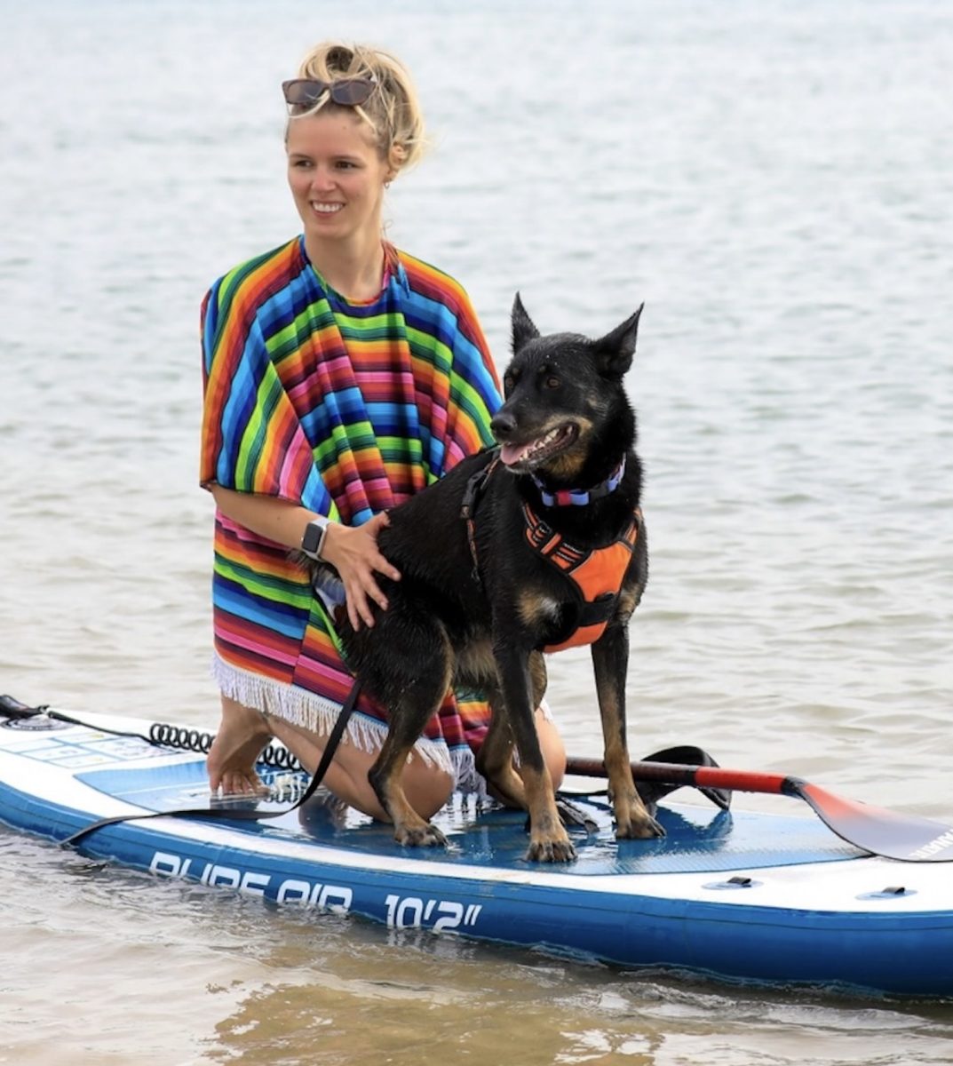 woman and dog on a river