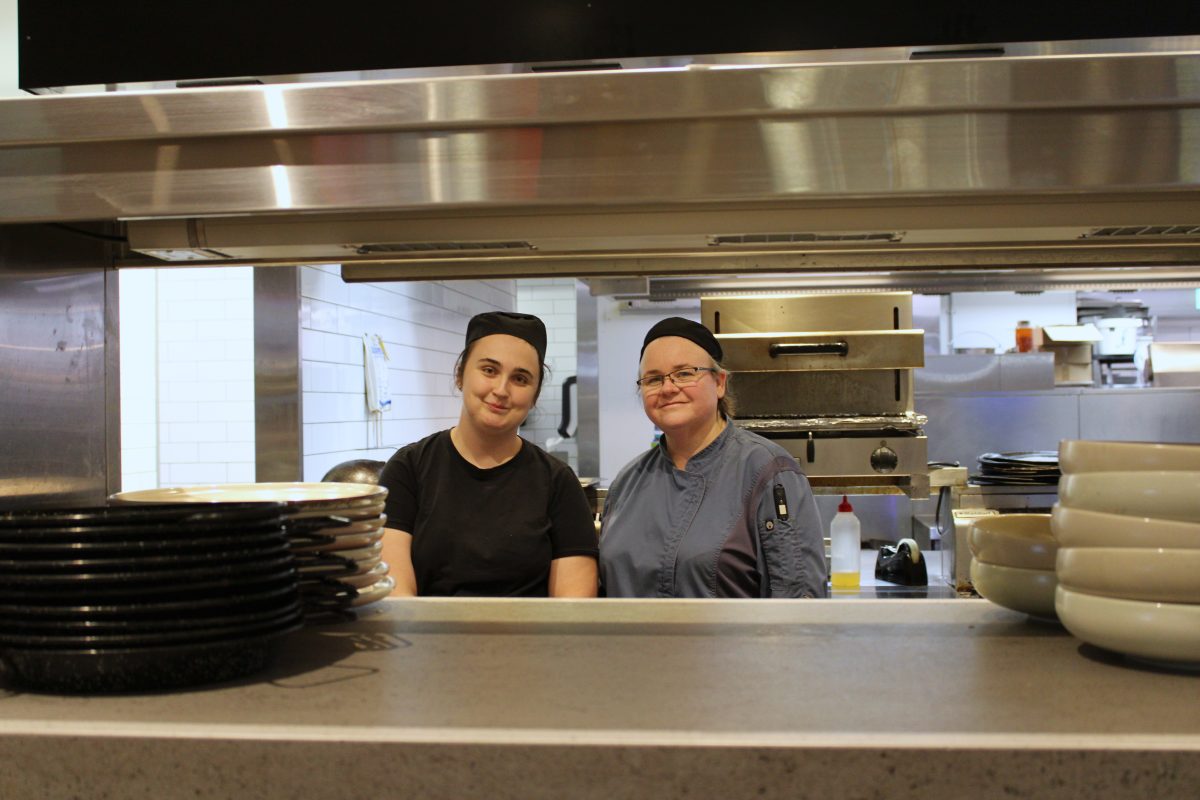 two women in a restaurant kitchen