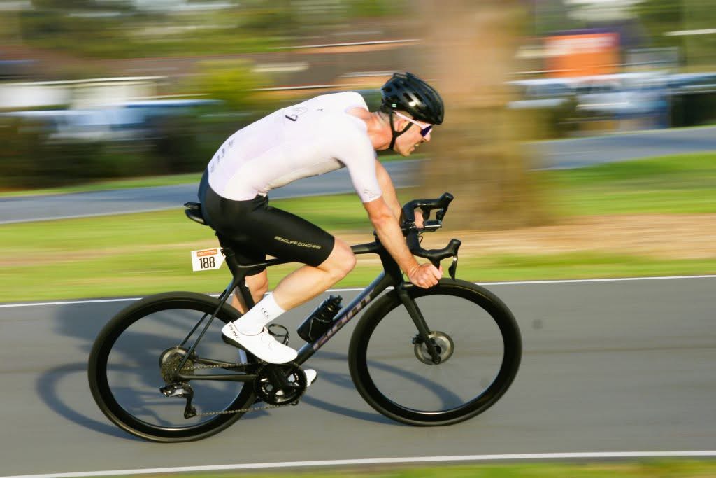 Young man races on a bike