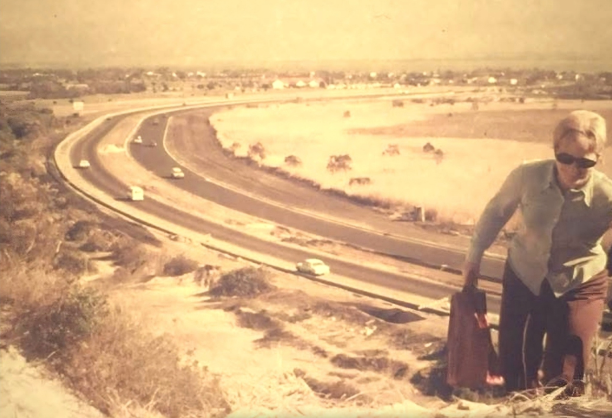 Woman climbing sand hill