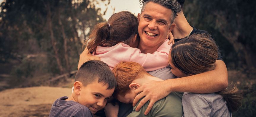 Father hugs his kids