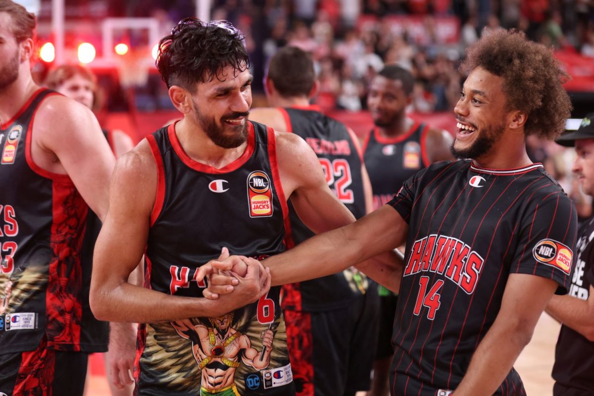 Biwali Bayles shares a moment with Hawks teammate “Dave” Hickey. 