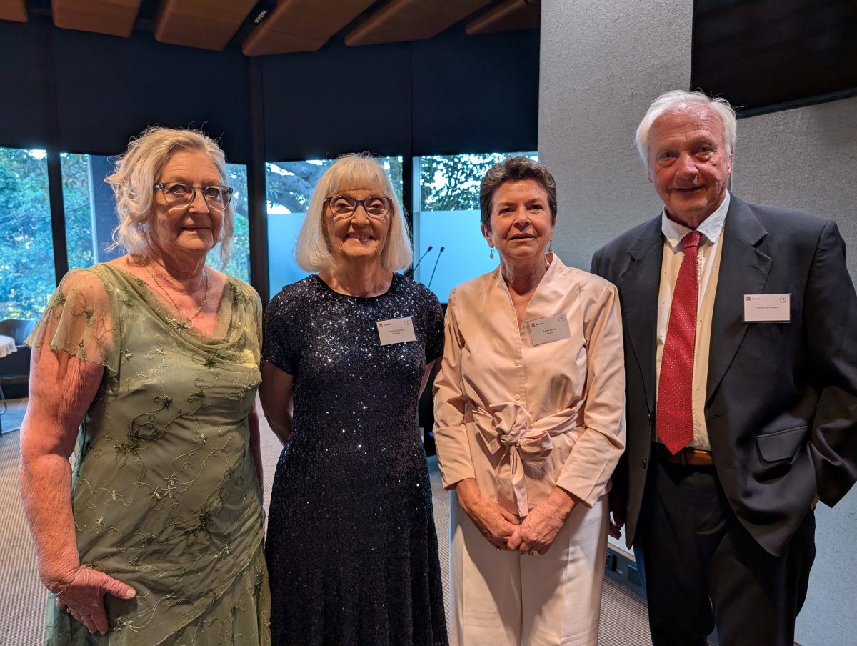 three women and a man standing in a line