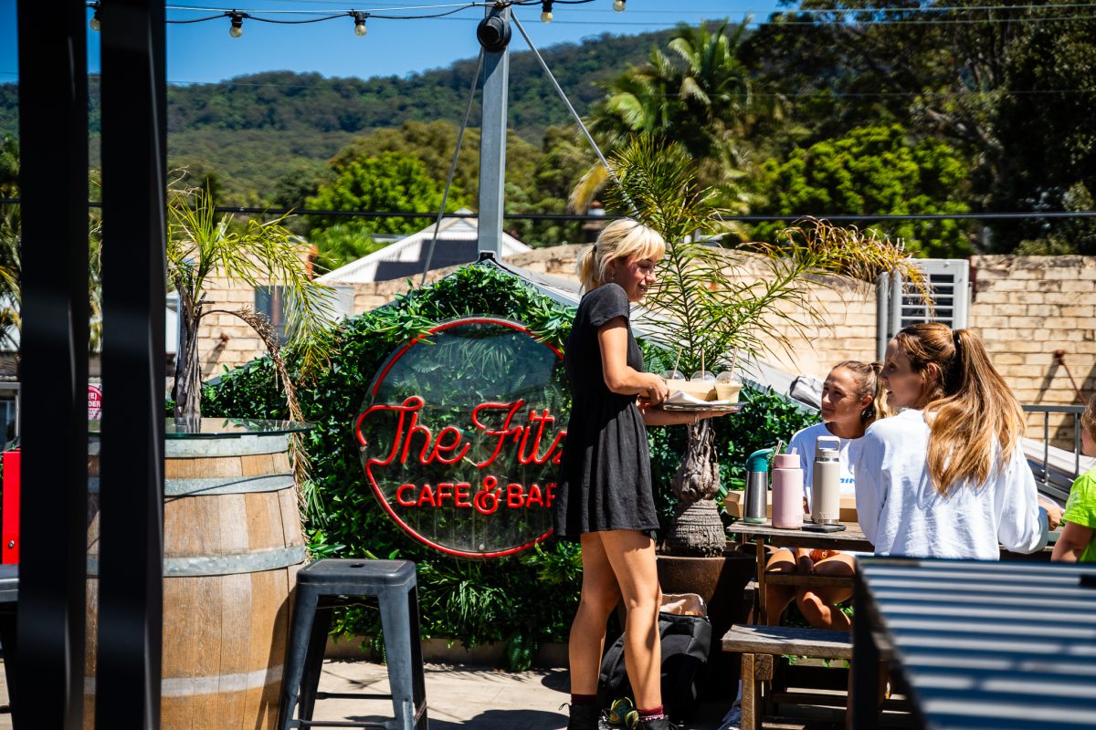 Waitress at The Fitz serves customers on the rooftop