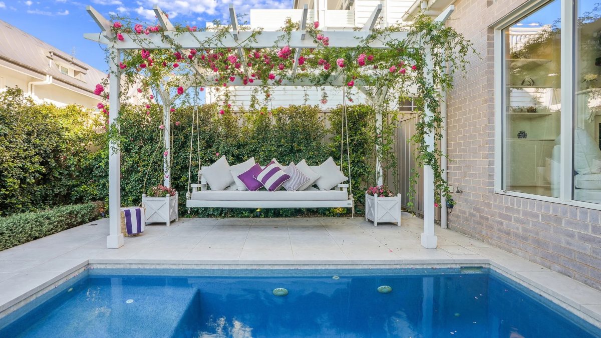 Pool with swing chair and creeping roses