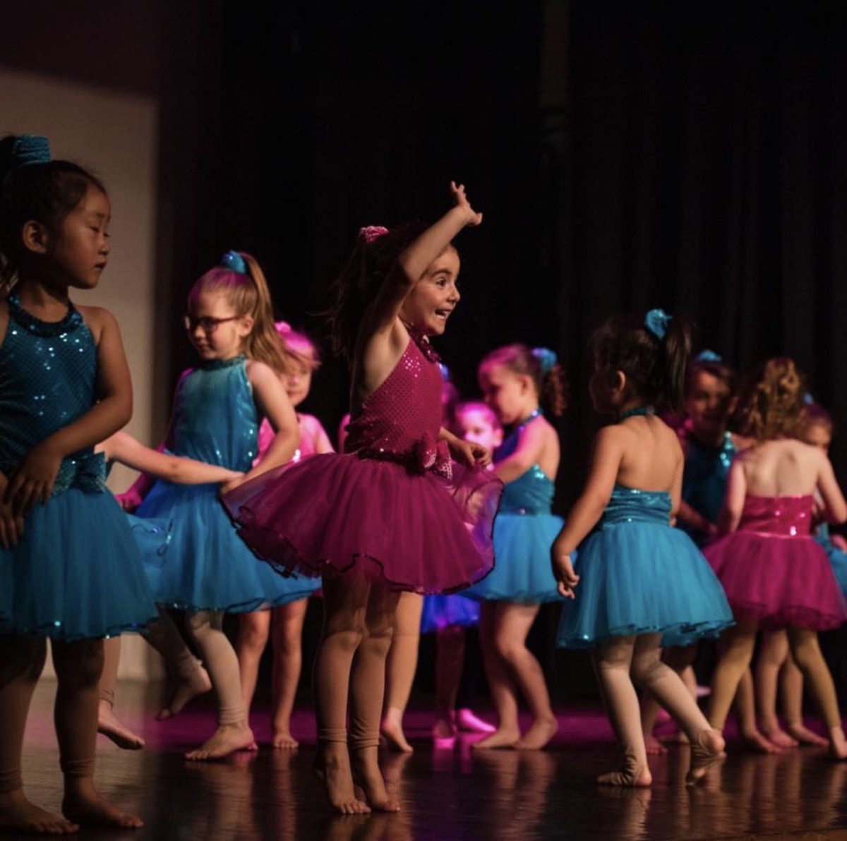 Young dancer smiling and waving 