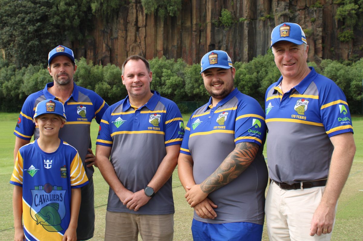 Cricketers standing on a field