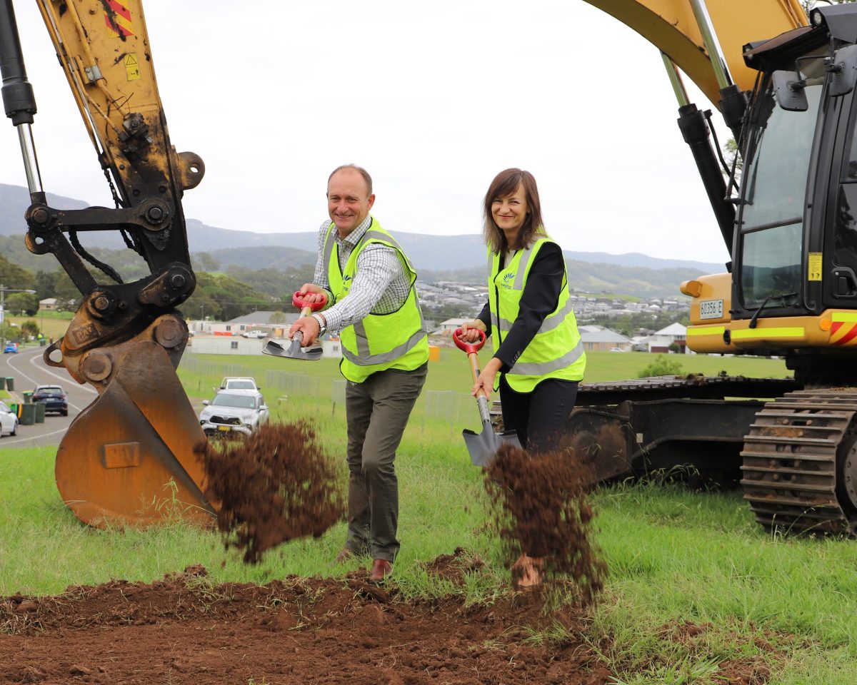 Two people digging dirt