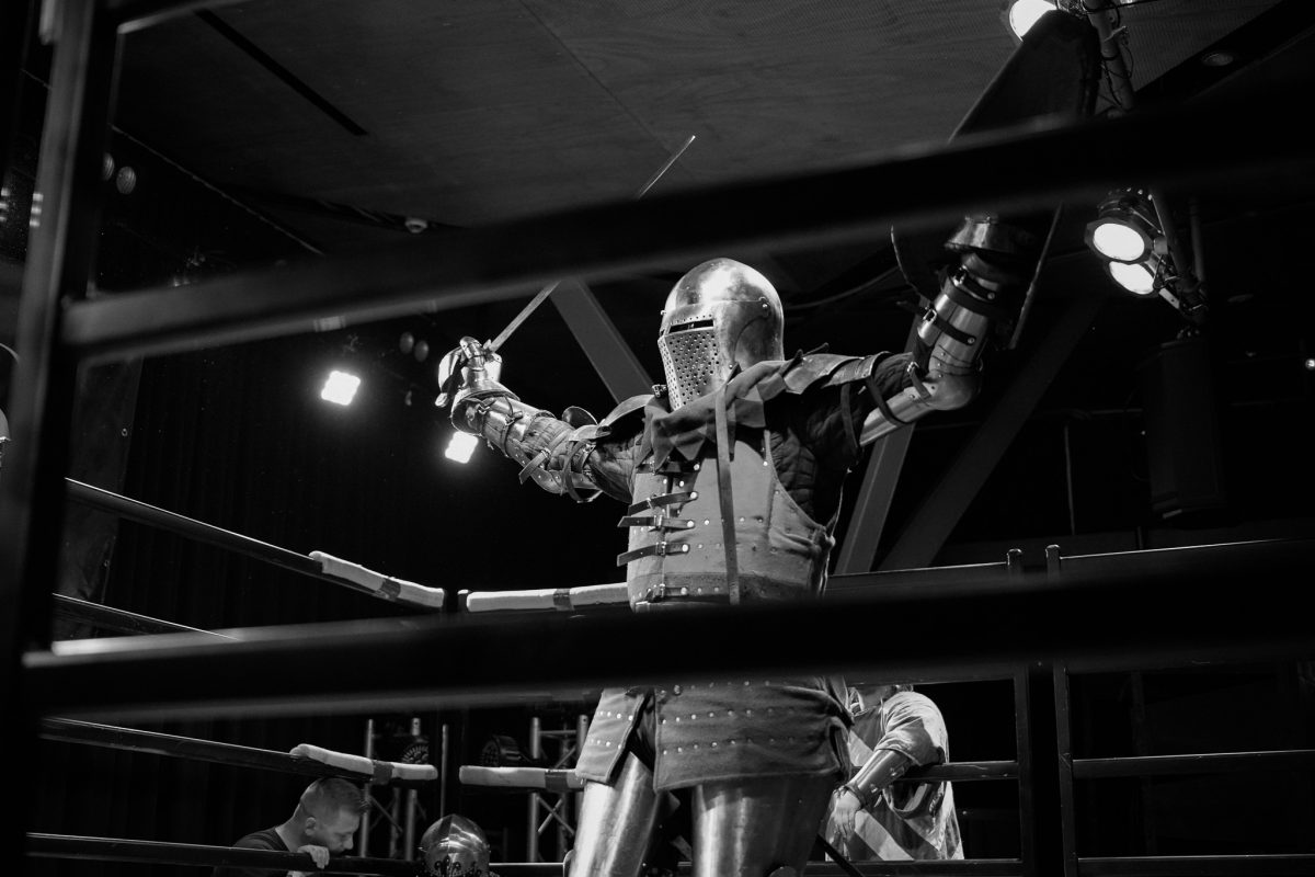 armoured fighter with sword in a cage