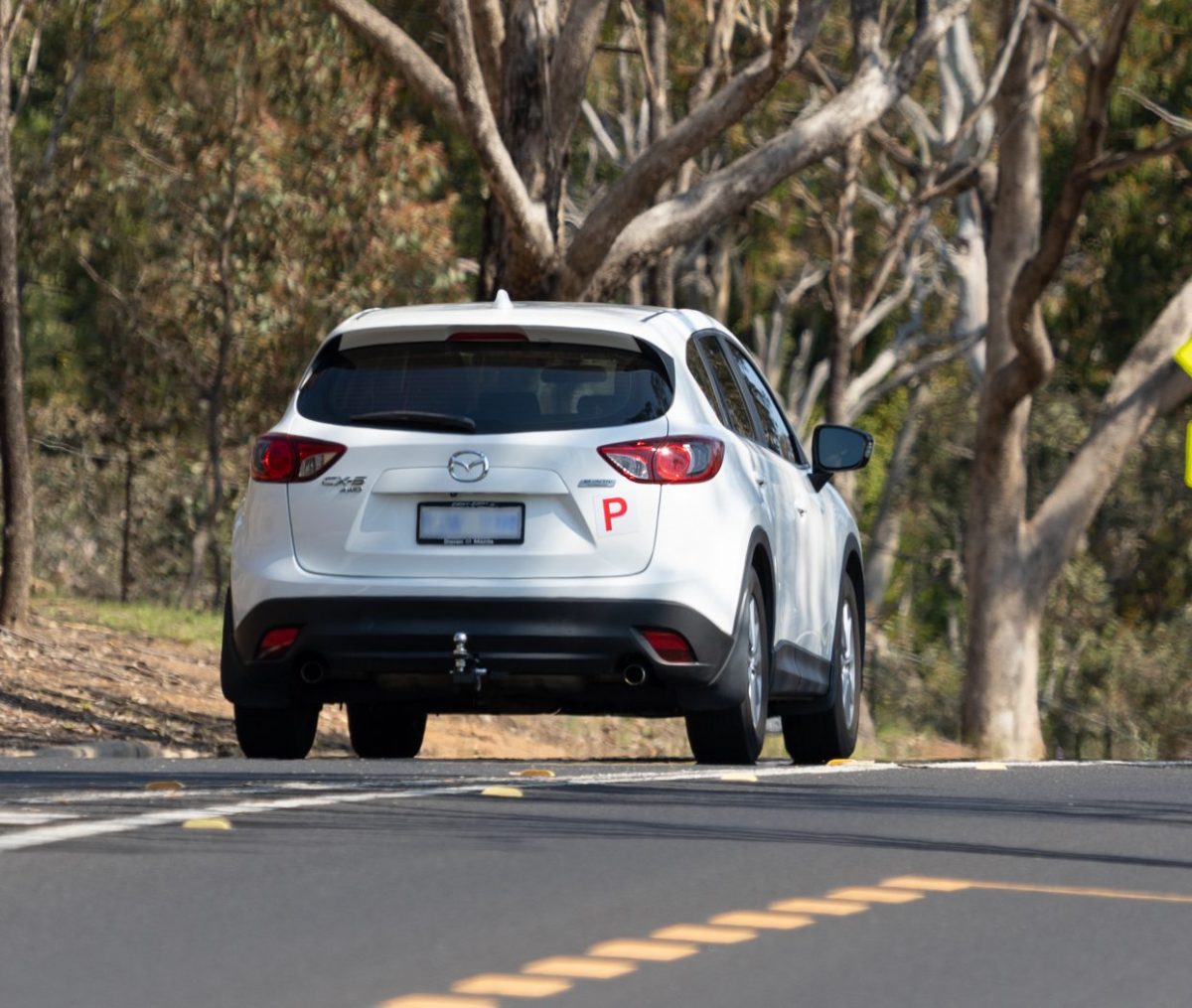 P-plated car being driven along a rural road 
