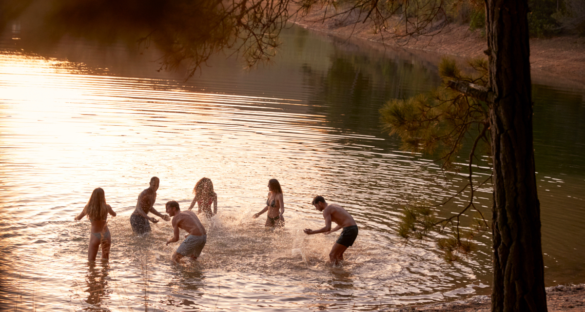 A group of young people playing in a river