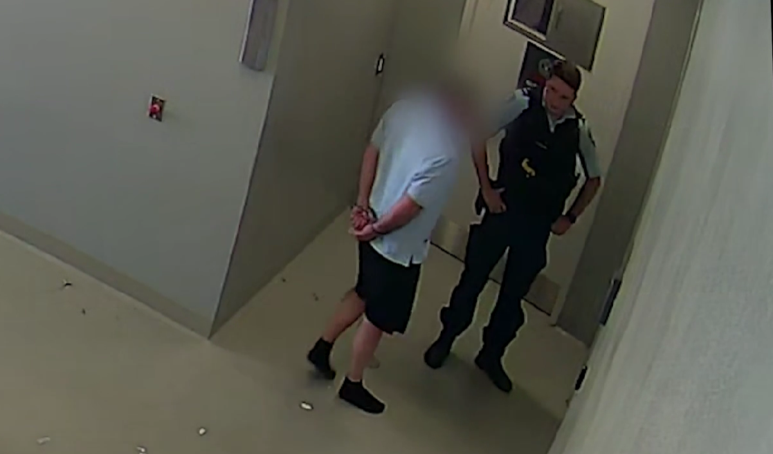 arrested man with police officer